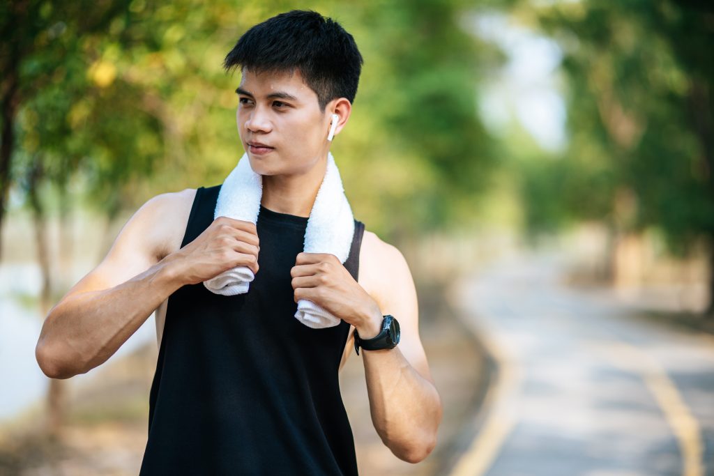 a man in a black shirt stood and held a handkerchief over his ne