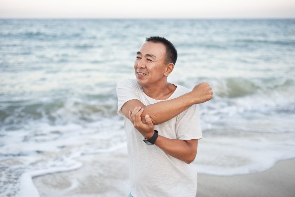 medium shot man stretching arm